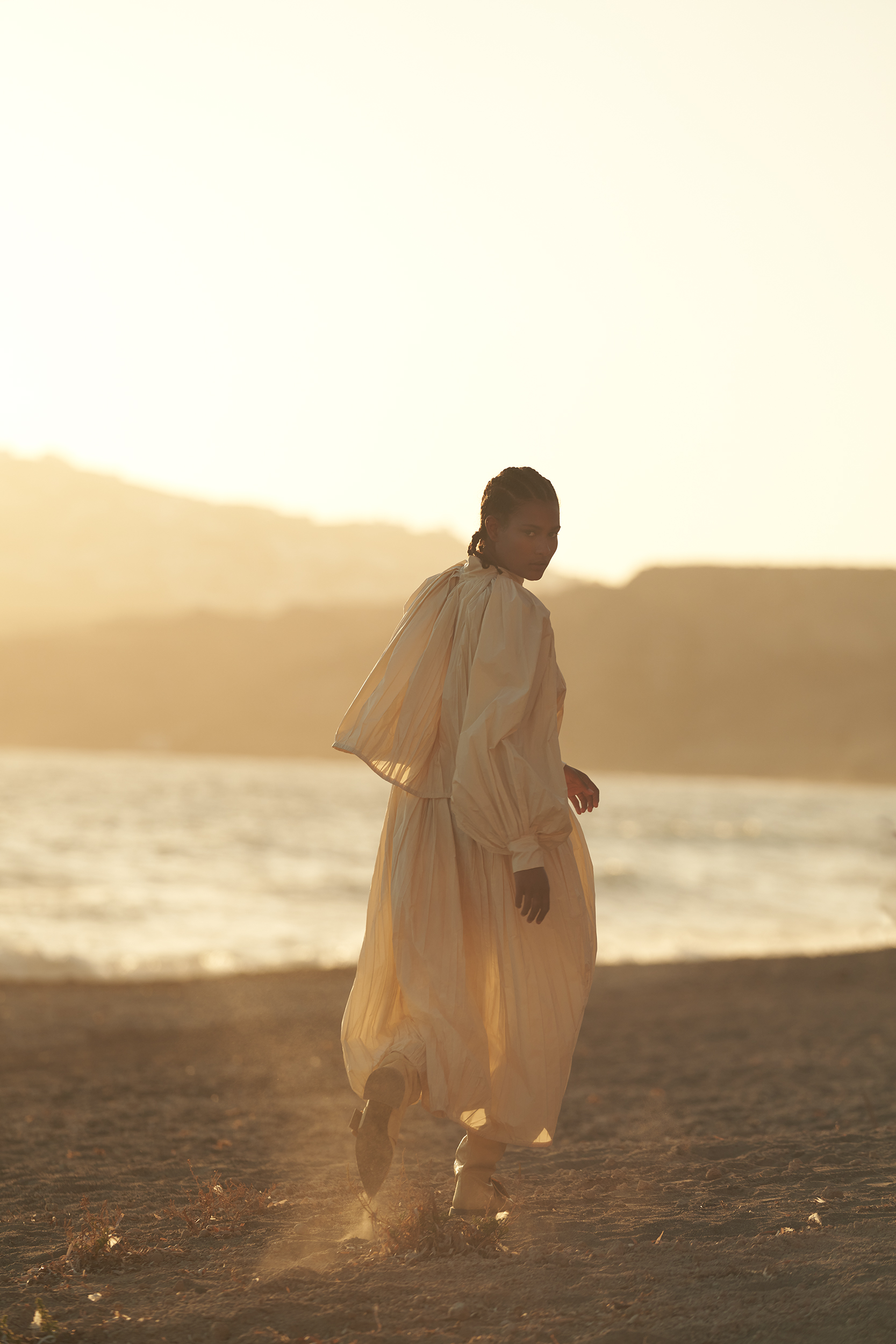 Model running on the beach wearing Jil Sander